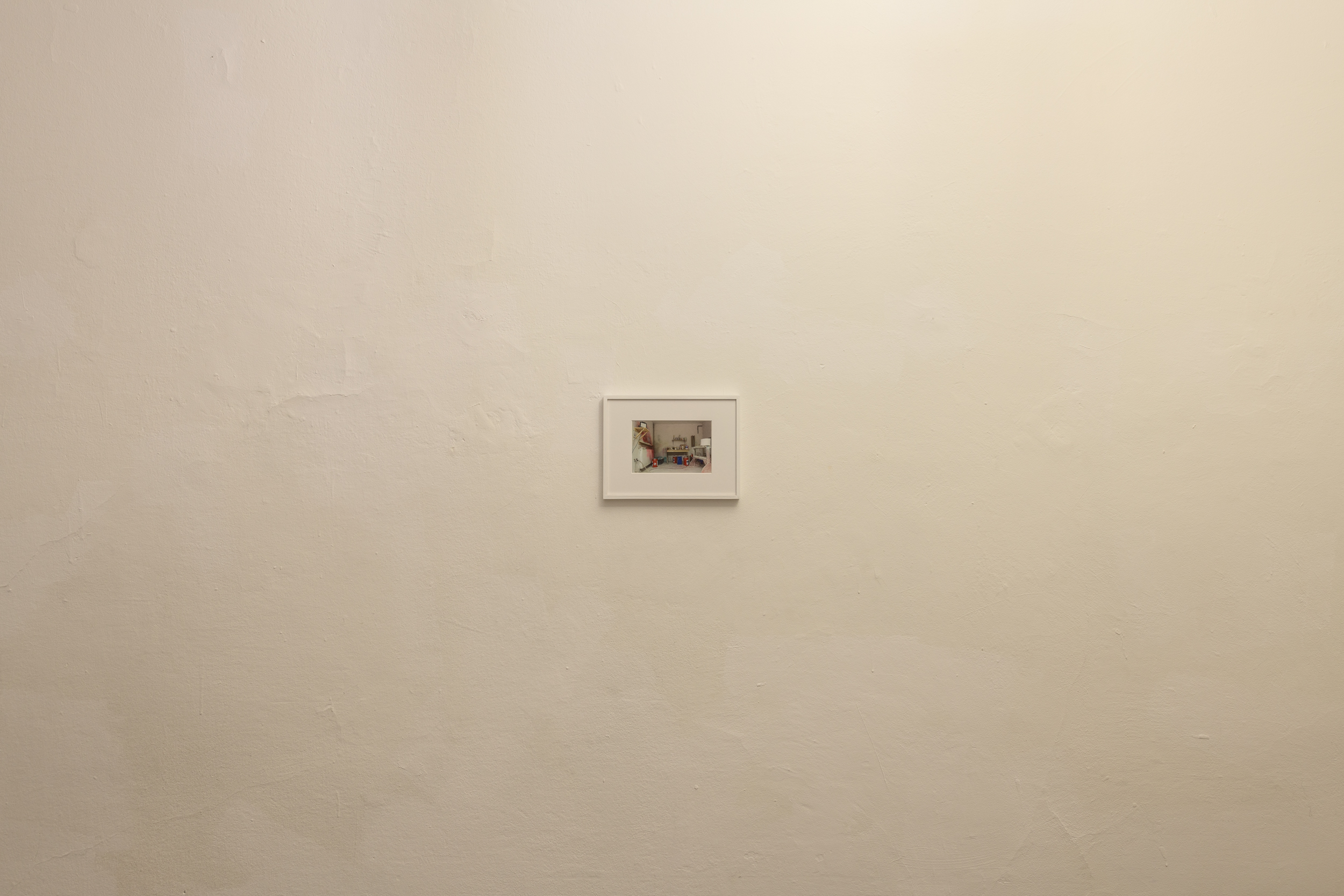 Aisha Altenhofen solo exhibition at Austin Space: View of the small photographic work on the wall in warm light.