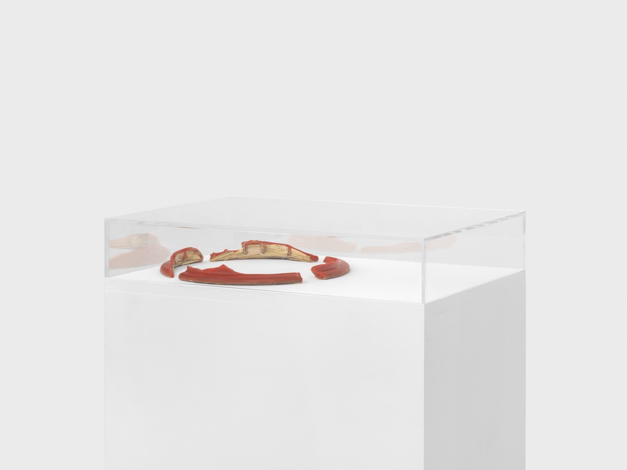 Aisha Altenhofen solo exhibition at Austin Space: View of the gallery room with the warm lighting, a bench table and black chairs and a single small photographic work on the wall.