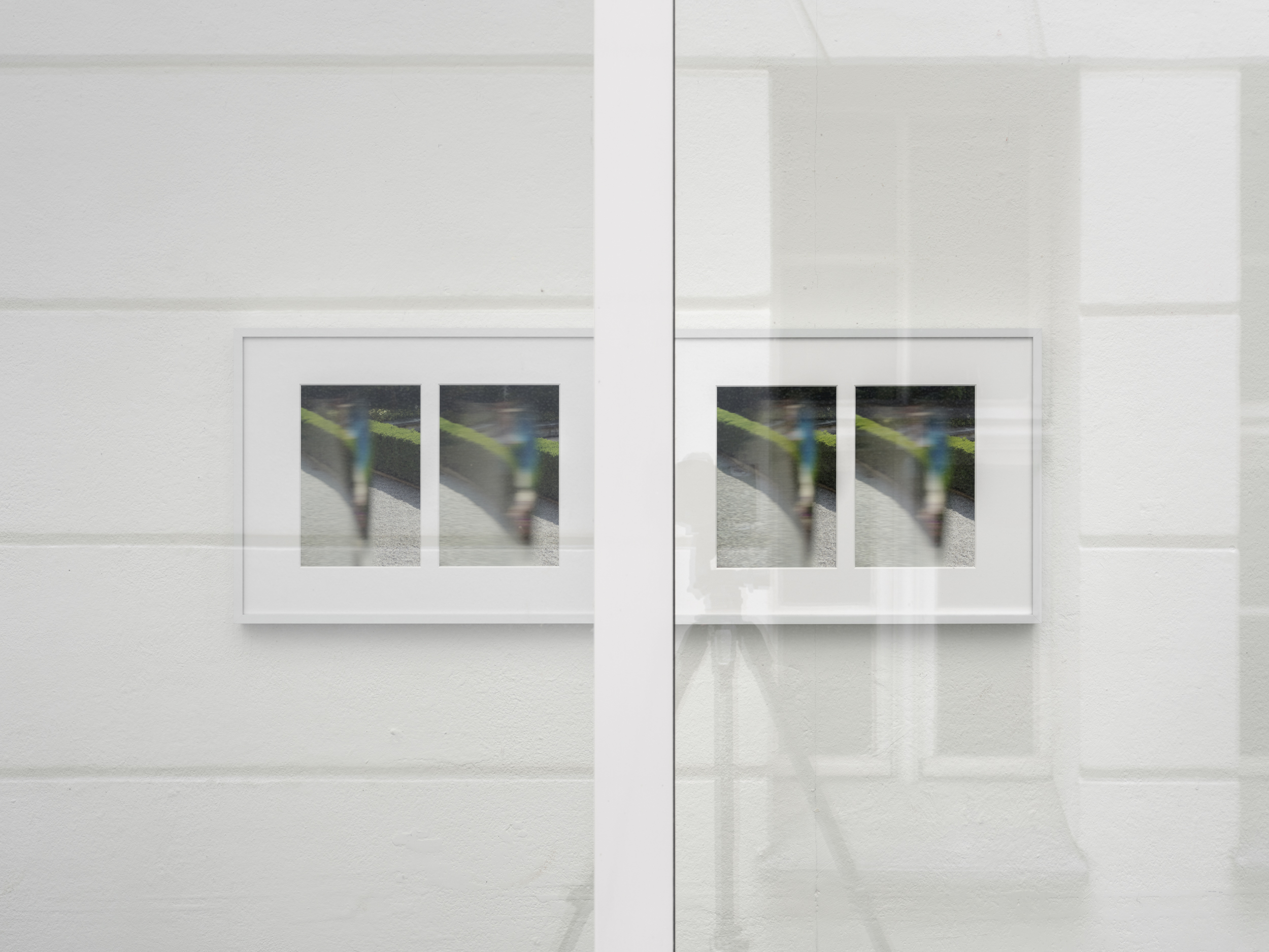 Aisha Altenhofen solo exhibition at Austin Space: Installation view of two white grid light fixtures installed at the wall, with an empty white wall between them.